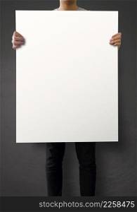 hipster holding blank poster on texture wall as concept
