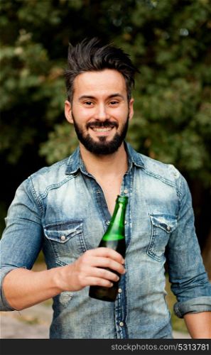 Hipster man with beard drinking a beer