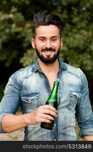 Hipster man with beard drinking a beer