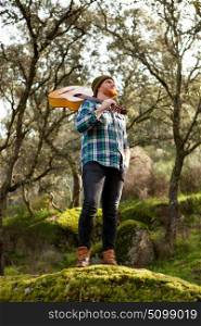 Hipster man with red beard and a guitar relaxs in the field