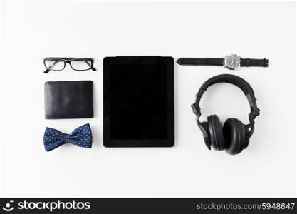 hipster personal stuff and objects concept - tablet pc computer, earphones, wallet, eyeglasses and wristwatch on table