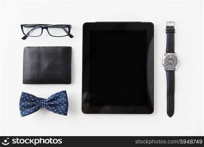 hipster personal stuff and objects concept - tablet pc computer, wallet, eyeglasses, bowtie and wristwatch on table