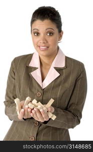 Hispanic business woman with wooden puzzle pieces in hand and frustrated expression.