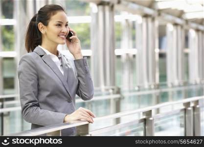 Hispanic Businesswoman Outside Office On Mobile Phone