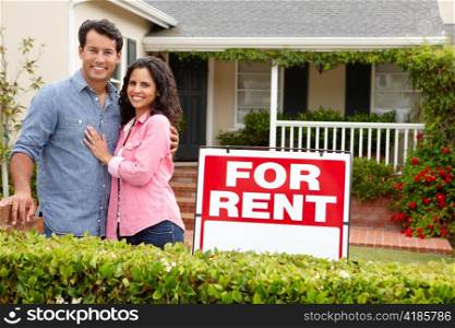 Hispanic couple outside home for rent
