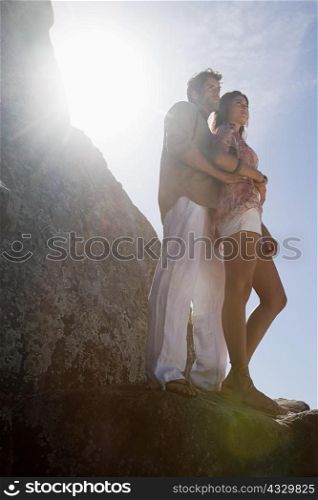 Hispanic couple standing in sunlight