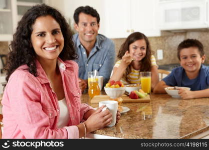 Hispanic family eating breakfast