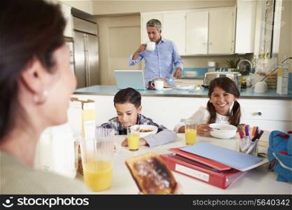 Hispanic Family Eating Breakfast At Home Before School
