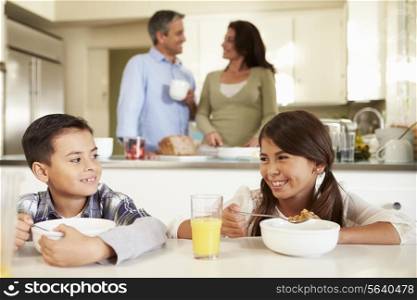 Hispanic Family Eating Breakfast At Home Together