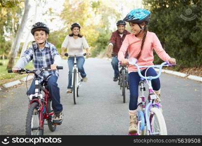 Hispanic Family On Cycle Ride In Countryside