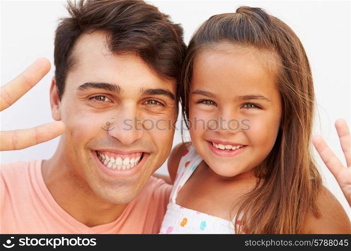 Hispanic Father And Daughter Making Peace Sign