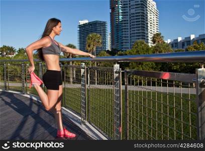 Hispanic girl in fitness clothing stretching
