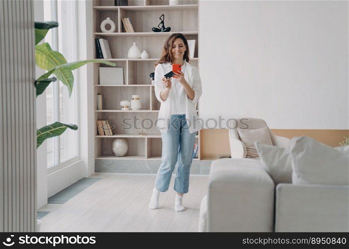 Hispanic girl is shopaholic. Lady holding credit card and te≤pho≠. Young attractive woman is going to buy through∫er≠t at home. Girl is booking or purchasing onli≠. Advertisement and commerce.. Attractive hispanic girl is shopaholic. Lady is holding card and going to buy through∫er≠t.