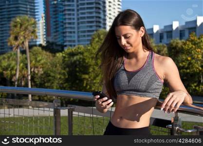 Hispanic girl listening to music during a fitness session