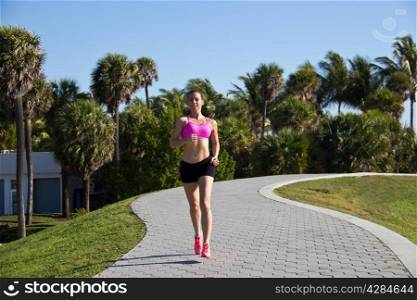 Hispanic girl running along a path