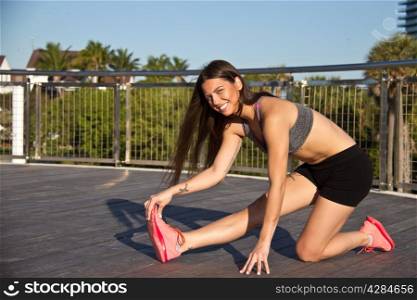 Hispanic girl stetches before a jog