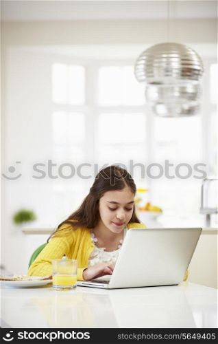 Hispanic Girl Using Laptop Eating Breakfast