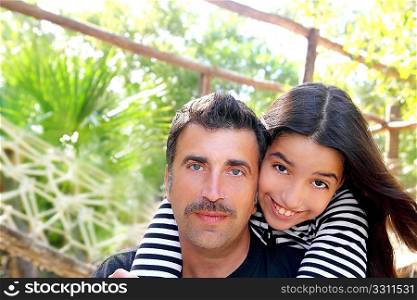 Hispanic latin father and teen daughter hug park outdoor Mexico
