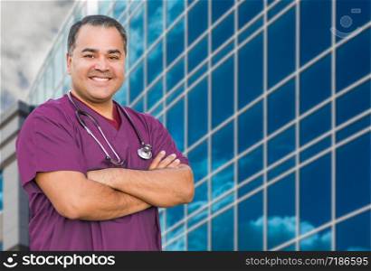 Hispanic Male Nurse In Front Of Hospital Building.