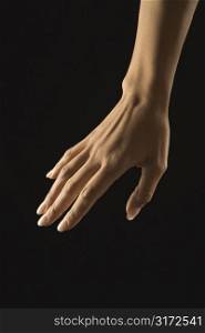 Hispanic mid adult female hand with manicure.