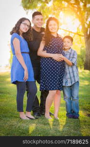 Hispanic Pregnant Family Portrait Outdoors.