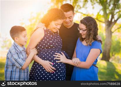 Hispanic Pregnant Family Portrait Outdoors.