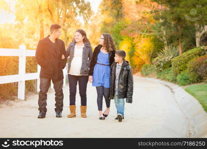 Hispanic Pregnant Family Walking On Path.