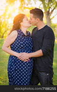 Hispanic Pregnant Young Couple Portrait Outdoors.