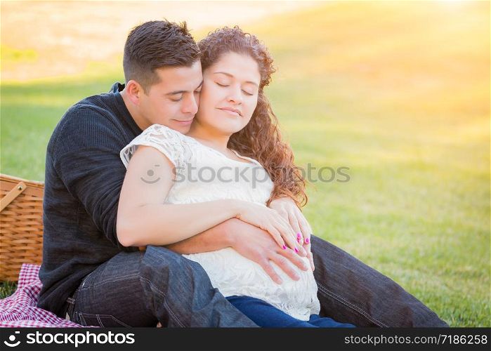 Hispanic Pregnant Young Couple Portrait Outdoors.