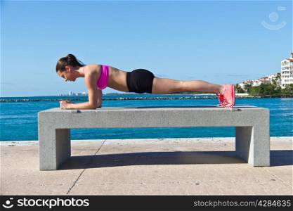 Hispanic woman doing a pilates plank for fitness