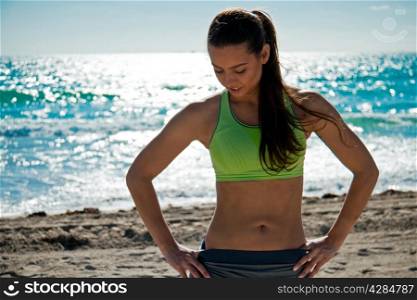 Hispanic woman getting ready for a beach workout