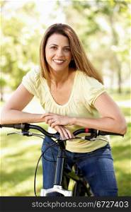 Hispanic woman in park with bike