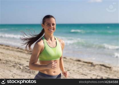Hispanic woman jogging on the beach