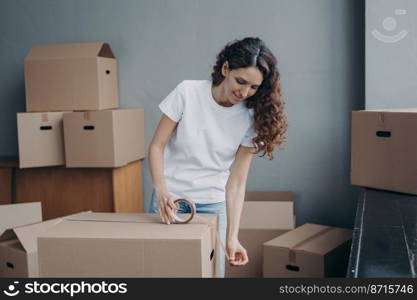 Hispanic woman packing goods in cardboard box, using adhesive scotch indoors. Delivery service female worker sealing carton package with sticky tape, preparing things for moving day.. Delivery service female worker using duct tape packing goods in cardboard box for transportation