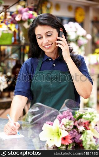 Hispanic woman working in florist