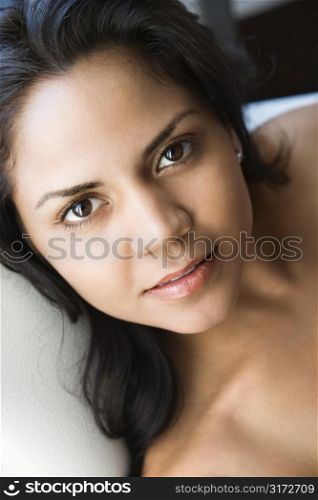 Hispanic young adult woman looking at viewer.