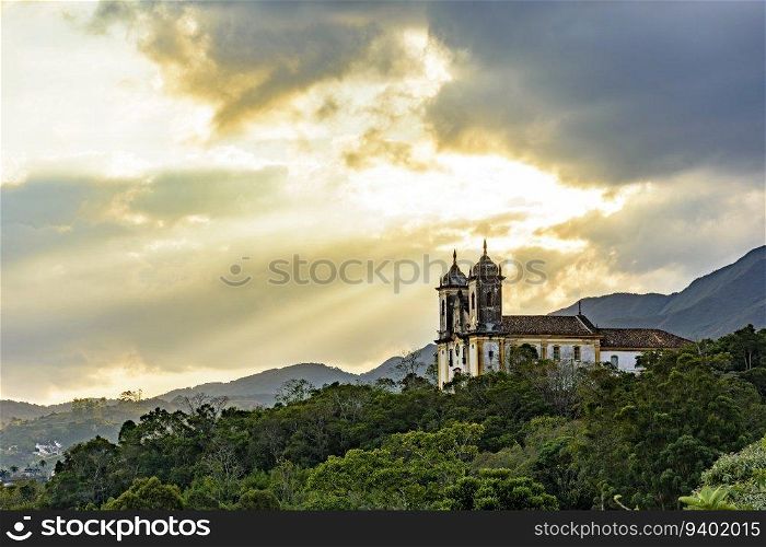 Historic baroque church on top of the hill and among the vegetation in the city of Ouro Preto in Minas Gerais. Historic baroque church on top of the hill