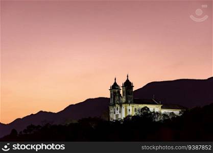 Historic baroque style church on top of the hill in Ouro Preto, Minas Gerais during sunset. Historic baroque style church on top of the hill