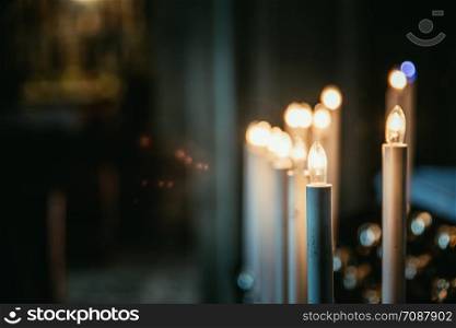 Historic catholic church: Close up picture of electric candles