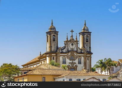 Historic church and its towers rising from among the colonial-style houses in the city of Ouro Preto in the state of Minas Gerais. Historic church and its towers rising from among the colonial-style houses