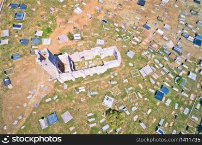 Historic church of Holy Salvation ruins and historic graveyard in Cetina aerial view, pre-romanesque church in Dalmatian hinterland of Croatia