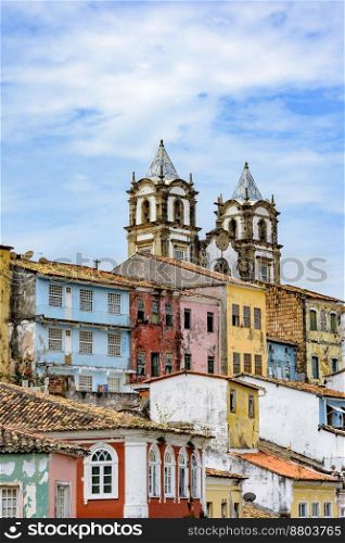 Historic church tower between the roofs and facades of houses in the famous Pelourinho neighborhood in Salvador Bahia. Historic church tower between the roofs and facades of houses in the Pelourinho
