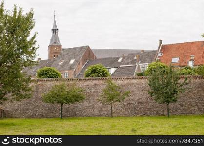 Historic city center behind ancient town wall at the city of Hattem, the Netherlands.