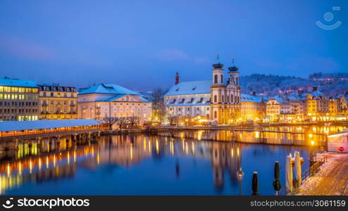 Historic city center of downtown Lucerne with Chapel Bridge and lake Lucerne in Switzerland at sunset