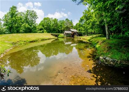 Historic Edwin B. Mabry Grist Mill (Mabry Mill) in rural Virginia on Blue Ridge Parkway and reflection on pond in summer