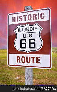 Historic Illinois Route 66 brown sign with sunset.