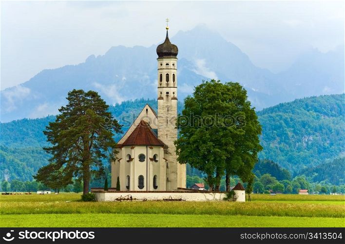 Historic medieval Neuschwanstein Castle in Bavaria (Germany) and church near