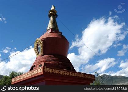 Historic red stupa in Tibet, against blue sky