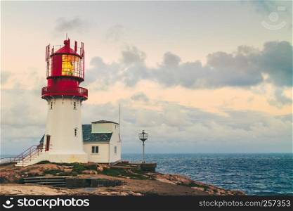 Historic red white lighthouse on the edge of rocky sea coast, South Norway, Lindesnes Fyr beacon. Lindesnes Lighthouse in Norway