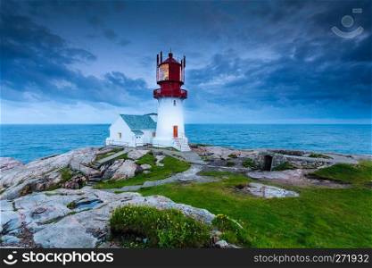 Historic red white lighthouse on the edge of rocky sea coast, South Norway, Lindesnes Fyr beacon. Lindesnes Lighthouse in Norway